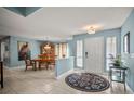 Light-filled foyer with neutral paint and tile flooring leads to the dining room at 7804 Broadmoor Pines Blvd, Sarasota, FL 34243