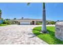 Beautiful single story home with a brick driveway, manicured landscaping, and a pristine two car garage at 7913 19Th Avenue W Dr, Bradenton, FL 34209