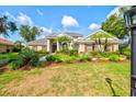 Charming home with a lush, green lawn, complemented by vibrant landscaping and a paver walkway at 8930 Bloomfield Blvd, Sarasota, FL 34238
