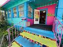 Charming, vibrantly painted home with mosaic tiled steps and colorful railings leading to a welcoming entrance at 1019 10Th W Ave, Bradenton, FL 34205