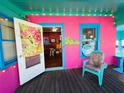 Bright pink art gallery exterior showcasing an open doorway with views of artwork inside at 1019 10Th W Ave, Bradenton, FL 34205