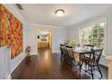 Bright dining room with hardwood floors and a large window overlooking the backyard at 102 28Th W St, Bradenton, FL 34205