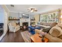 Cozy living room featuring a fireplace, neutral-toned furniture, and a large window with a view at 102 28Th W St, Bradenton, FL 34205