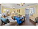 Spacious living room with hardwood floors, comfortable seating, and bright natural light at 102 28Th W St, Bradenton, FL 34205