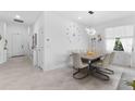 Bright dining room featuring a modern table set, decorative wall clock, and stylish decor at 10868 Sun Drop St, Venice, FL 34293