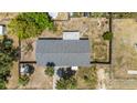 Aerial shot of the home's roof and backyard, highlighting the yard's fencing and mature trees at 112 E Marland Ct, Nokomis, FL 34275