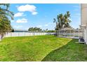 Spacious backyard features a well-maintained lawn and screened-in pool, great for outdoor enjoyment at 1723 Laramie St, Sarasota, FL 34231