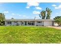 Charming single-story home boasts a well-manicured lawn, blue shutters and a one car garage at 1723 Laramie St, Sarasota, FL 34231