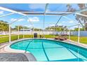 Relaxing screened-in pool area with lounge chairs and plenty of space to enjoy the outdoors at 1723 Laramie St, Sarasota, FL 34231
