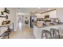 Modern kitchen featuring stainless steel appliances, granite countertops, and ample cabinet space at 17377 Whiskey Creek Trl, Parrish, FL 34219