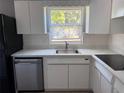 Bright kitchen featuring stainless steel appliances, white cabinets, and a sunlit window at 2833 62Nd N St, St Petersburg, FL 33710