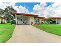 Single-story home with a covered parking area and well manicured landscaping at 3213 Mercer Rd, Bradenton, FL 34207