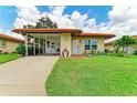 Well-maintained single-story home with mature landscaping and a terracotta roof at 3213 Mercer Rd, Bradenton, FL 34207
