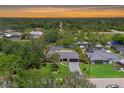 Beautiful aerial view of a single-Gathering home with mature trees, a backyard pool and canal access at 3500 Liberty St, Port Charlotte, FL 33948