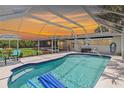 A clear view of the screened in pool, with clear blue water and a diving board at 3500 Liberty St, Port Charlotte, FL 33948