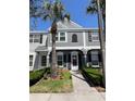 Inviting two-story townhome with a gray exterior, black shutters, and maintained front lawn at 396 Countryside Key Blvd, Oldsmar, FL 34677