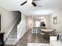 Open floor plan showcasing the living and dining area with stairway, flowing into the kitchen at 396 Countryside Key Blvd, Oldsmar, FL 34677