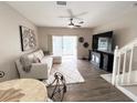 Bright living room with cozy seating, modern TV console and view to the exterior at 396 Countryside Key Blvd, Oldsmar, FL 34677