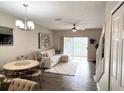 Open living space with tile floors, neutral decor, and a sliding glass door at 396 Countryside Key Blvd, Oldsmar, FL 34677