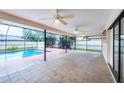 Spacious screened patio with ceiling fans overlooking a sparkling pool, ideal for outdoor entertaining at 408 Fletcher St, Port Charlotte, FL 33954