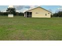 The rear of the home showcases a screened lanai and a large, green backyard at 4353 Hidden River Rd, Sarasota, FL 34240