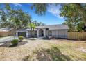 Inviting single-story home featuring a lush landscaped front yard and a convenient two-car garage at 4473 Diamond S Cir, Sarasota, FL 34233