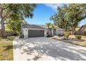 Beautiful single-story home with large driveway, lush landscaping and a well-maintained lawn at 4473 Diamond S Cir, Sarasota, FL 34233