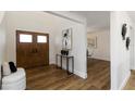 Inviting entryway featuring wood floors, a stylish console table, and a modern art piece at 4506 17Th W St, Palmetto, FL 34221