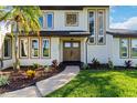 Beautifully landscaped home exterior with well-manicured lawn and charming walkway leading to a double door entry at 4506 17Th W St, Palmetto, FL 34221