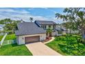 A lovely aerial view of a house featuring a large front yard and a spacious driveway leading to the garage at 4506 17Th W St, Palmetto, FL 34221