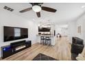 Open-concept living area features a modern fireplace, wood floors, and seamless kitchen access at 4833 San Palermo Dr, Bradenton, FL 34208