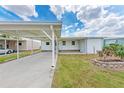 Well-maintained exterior showcasing the carport, entryway, and simple landscaping at 5619 Bayshore Rd # 203, Palmetto, FL 34221