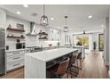 Modern kitchen boasts an expansive island, stainless steel appliances, and stylish pendant lighting at 5646 Simonton St, Bradenton, FL 34203