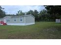 Spacious backyard with lush green grass, ideal for outdoor activities at 6238 Angus Valley Dr, Wesley Chapel, FL 33544
