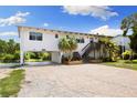 Charming waterfront home boasting ample parking, lovely landscaping, and convenient under-house access at 6406 Lincoln Rd, Bradenton, FL 34203