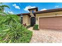 Close-up of a well-maintained home exterior showcasing a secure front door and lush landscaping at 6756 Chester Trl, Lakewood Ranch, FL 34202