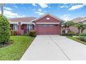Beautiful home featuring a well-manicured lawn, palm trees and a long driveway leading to an attached garage at 7314 Hamilton Rd, Bradenton, FL 34209