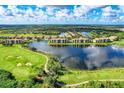 Scenic aerial view of the community showcasing beautiful lakes, lush landscaping, and well-maintained golf courses at 7911 Grand Estuary Trl # 102, Bradenton, FL 34212