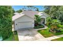 Aerial view of a well-maintained home with lush landscaping and an attached garage at 8047 Desoto Woods Dr, Sarasota, FL 34243