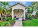 Charming home exterior with landscaped front yard and covered entrance at 8047 Desoto Woods Dr, Sarasota, FL 34243