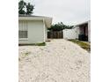 Backyard features white rock, fencing, and access to the neighbor's property at 8409 43Rd W Ave, Bradenton, FL 34209