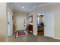 Welcoming foyer featuring neutral walls, tile flooring, and decorative accents adding warmth and character to the entrance at 915 Sw Barclay Ct, Venice, FL 34293