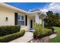 Inviting front entrance with a well-maintained lawn, neatly trimmed shrubs, and a welcoming walkway to the front door at 915 Sw Barclay Ct, Venice, FL 34293