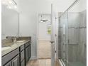 Modern bathroom boasts a double vanity with granite counters and a glass-enclosed shower at 11194 Spring Point Cir, Riverview, FL 33579