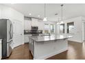 Bright kitchen features a large island, granite countertops, stainless appliances, and ample natural light at 11194 Spring Point Cir, Riverview, FL 33579