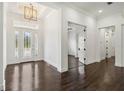 Bright foyer with elegant glass-paneled double doors and dark hardwood floors at 1015 143Rd Ne St, Bradenton, FL 34212