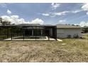 A backyard swimming pool with screened enclosure provides outdoor enjoyment at 1036 Arden Nw Ter, Port Charlotte, FL 33948