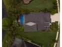 Aerial view of the home, pool area, well-maintained yard, and surrounding landscaping at 12015 Forest Park Cir, Bradenton, FL 34211