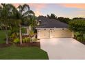 Attractive home featuring a well-maintained lawn, mature landscaping, and a spacious two-car garage at 12015 Forest Park Cir, Bradenton, FL 34211