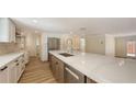 Bright, open kitchen with stainless steel appliances, large island, and modern countertops at 1203 Lyric Ln, Sarasota, FL 34242